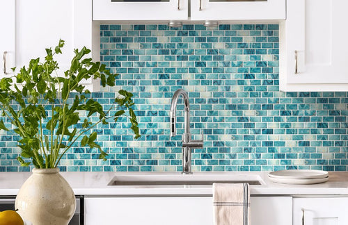 aqua kitchen tile backsplash with a sink and plant