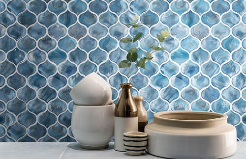 arabesque kitchen tile backsplash with cups, a plant and a bowl