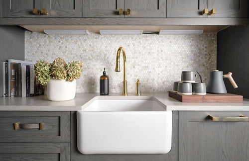 athena series stone tile backsplash behind a sink and a plant