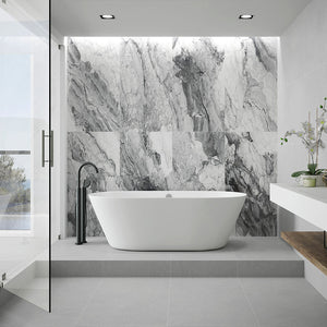 White and gray stone-look porcelain tile on bathroom shower wall with white soaking tub