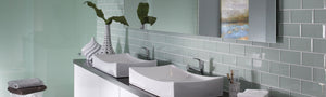 Gray glass subway tile on bathroom wall and bathroom vanity