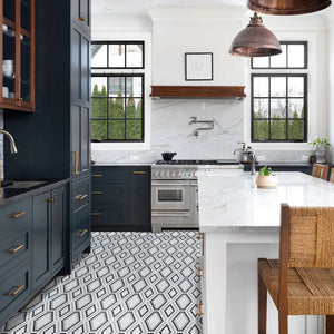 Black and white patterned glass tile on kitchen floor with white kitchen backsplash