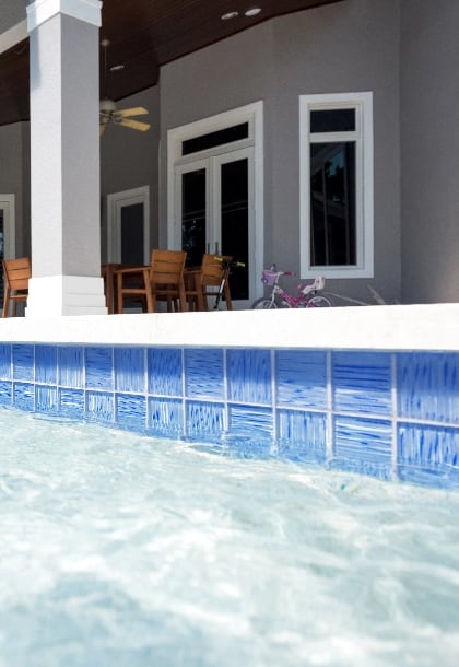 Light blue, glass waterline tile in pool